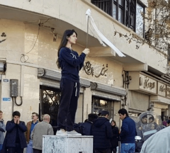 Vida Movahed waving a white headscarf in Tehran